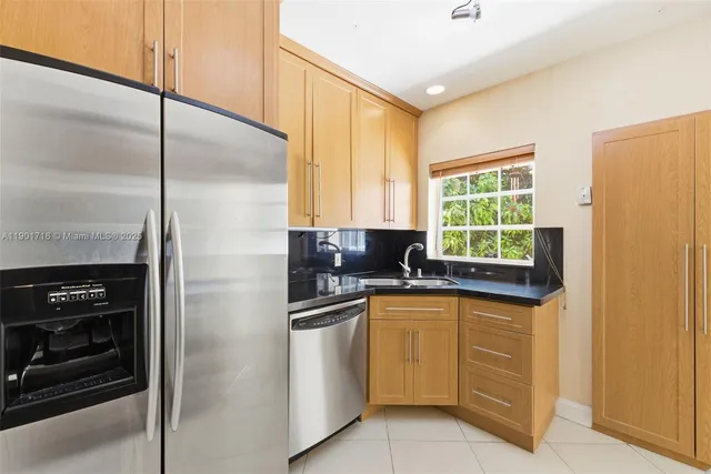 a kitchen with a sink a refrigerator and window