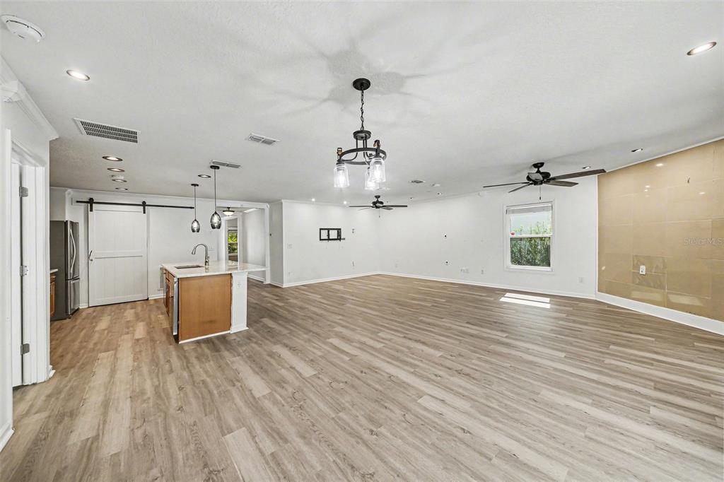111 Lakeside Court Bunnell, FL 32110 - Photo 14 of 27 a view of a room with wooden floor ceiling fan and windows