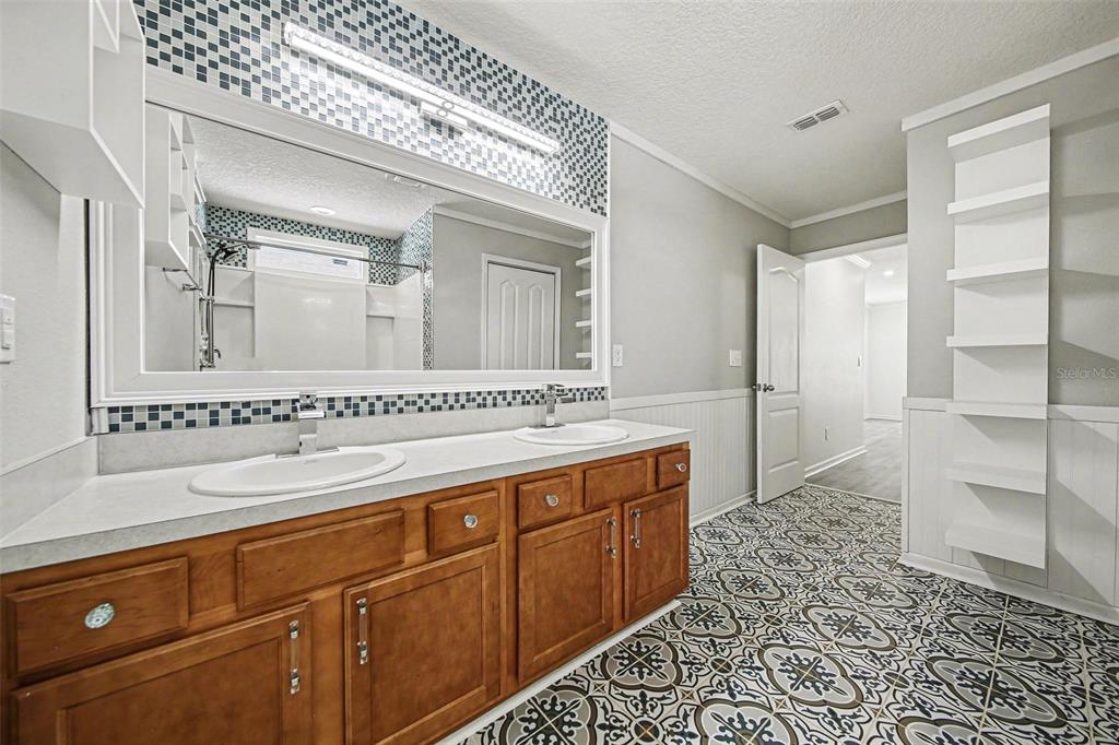 111 Lakeside Court Bunnell, FL 32110 - Photo 20 of 27 a bathroom with a sink a mirror and a shower