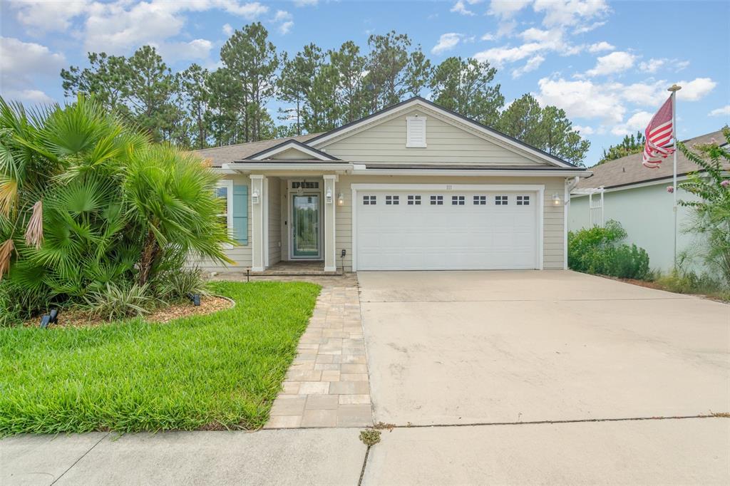 111 Lakeside Court Bunnell, FL 32110 - Photo 2 of 27 a front view of a house with a yard and garage