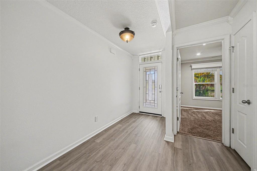 111 Lakeside Court Bunnell, FL 32110 - Photo 4 of 27 wooden floor in an empty room with a window