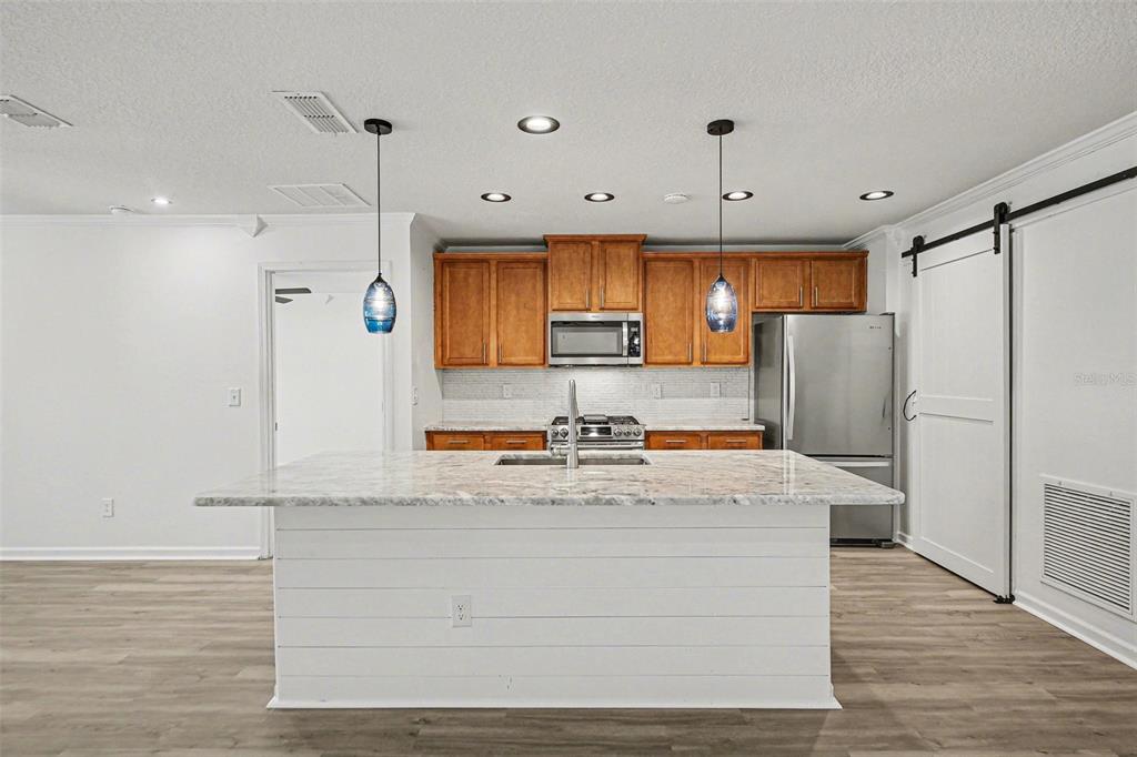 111 Lakeside Court Bunnell, FL 32110 - Photo 5 of 27 a view of kitchen with stainless steel appliances granite countertop cabinets and wooden floor