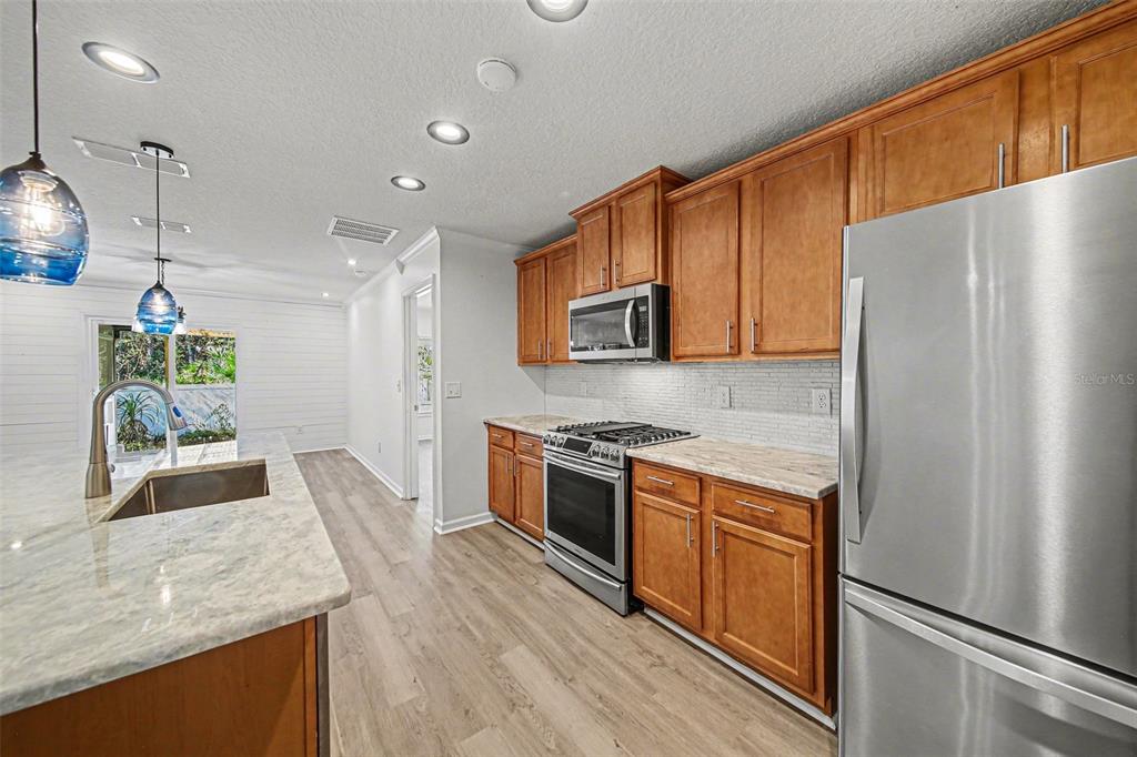 111 Lakeside Court Bunnell, FL 32110 - Photo 6 of 27 a kitchen with stainless steel appliances granite countertop a refrigerator a stove top oven a sink and dishwasher