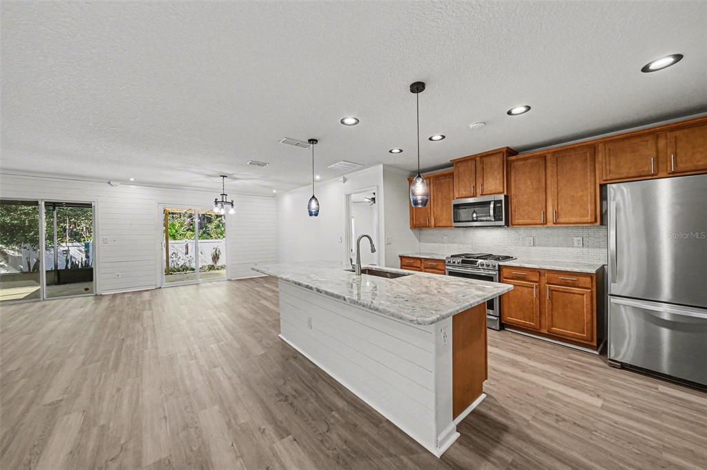 111 Lakeside Court Bunnell, FL 32110 - Photo 7 of 27 a kitchen with a refrigerator a sink and wooden floor