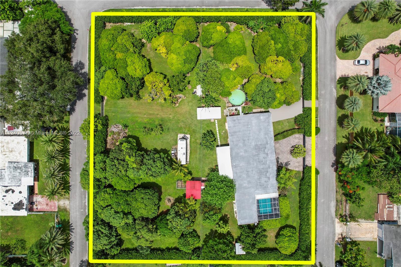 an aerial view of a brick house with a yard and plants
