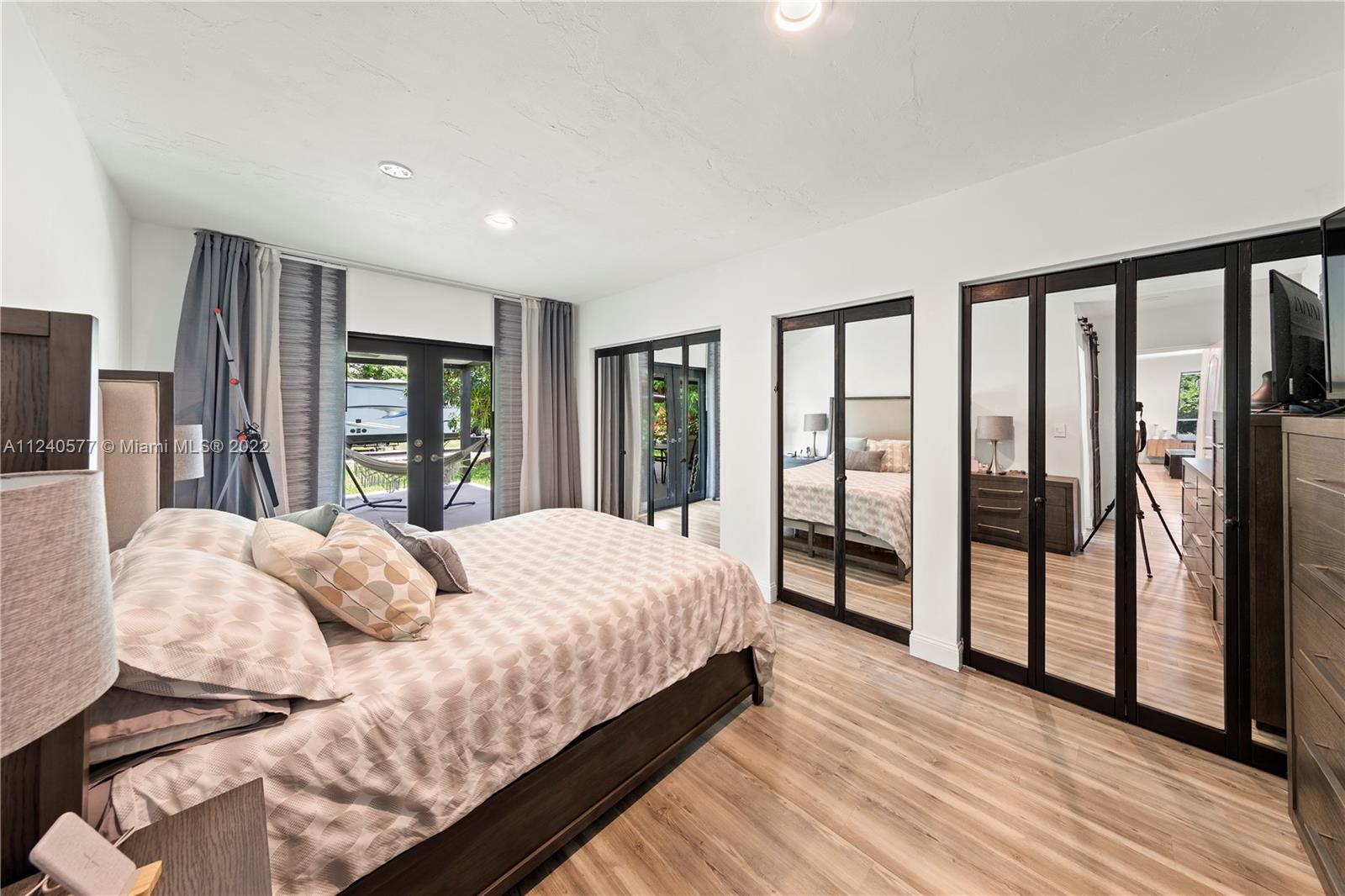 19760 Southwest 242nd Terrace Homestead, FL 33031 - Photo 14 of 49 a bedroom with a large bed and a large window