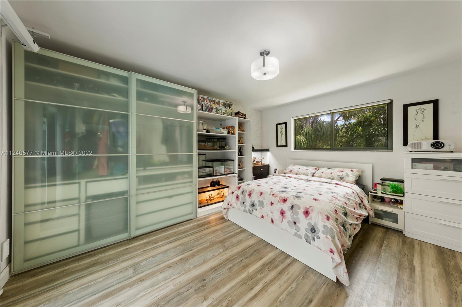 19760 Southwest 242nd Terrace Homestead, FL 33031 - Photo 17 of 49 a bedroom with a bed and a dresser