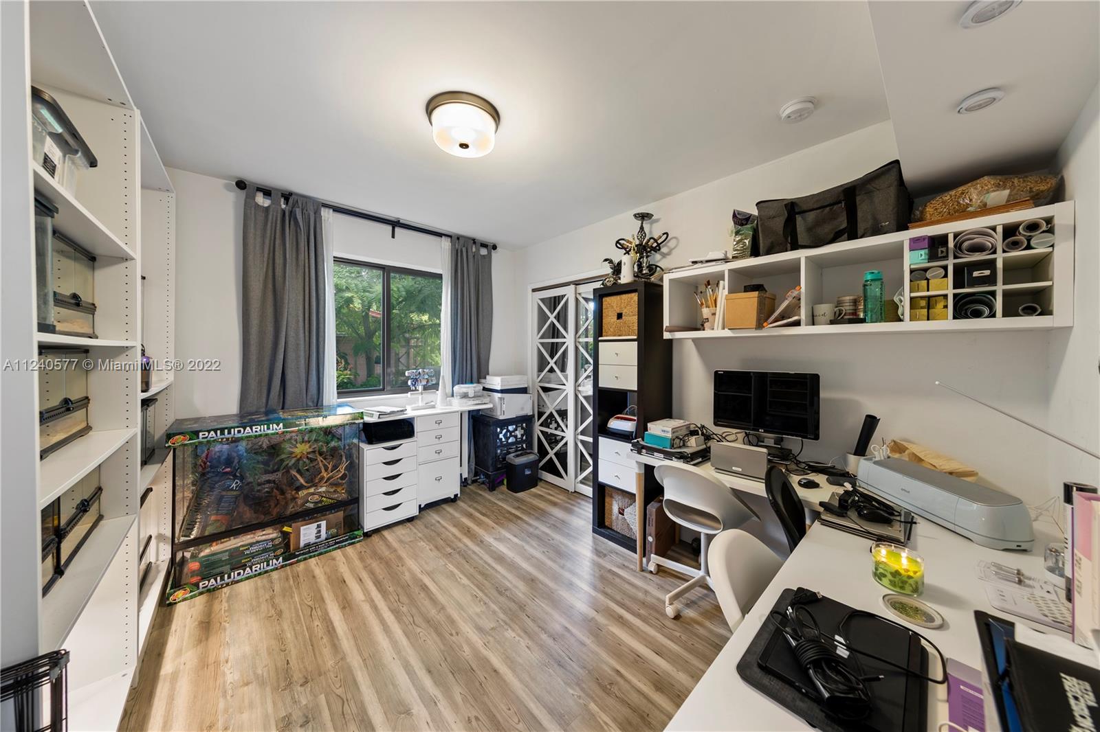 19760 Southwest 242nd Terrace Homestead, FL 33031 - Photo 19 of 49 a view of a workspace with furniture and a window