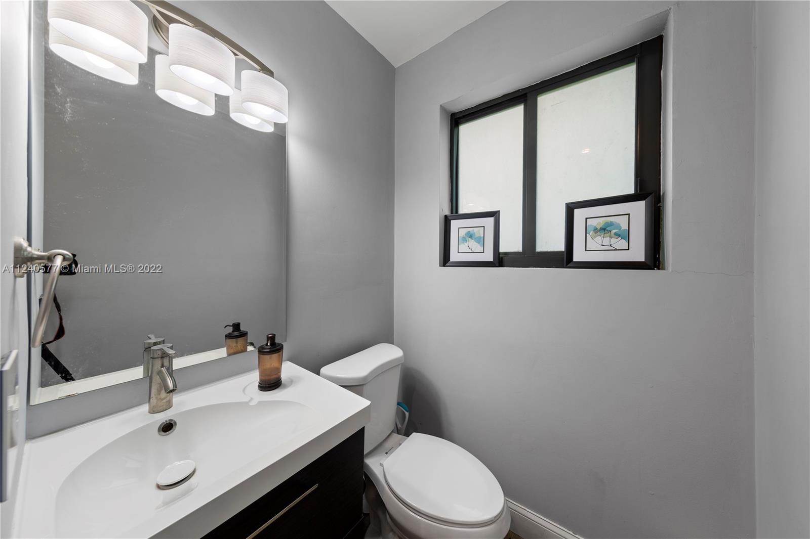 19760 Southwest 242nd Terrace Homestead, FL 33031 - Photo 20 of 49 a bathroom with a sink mirror and toilet