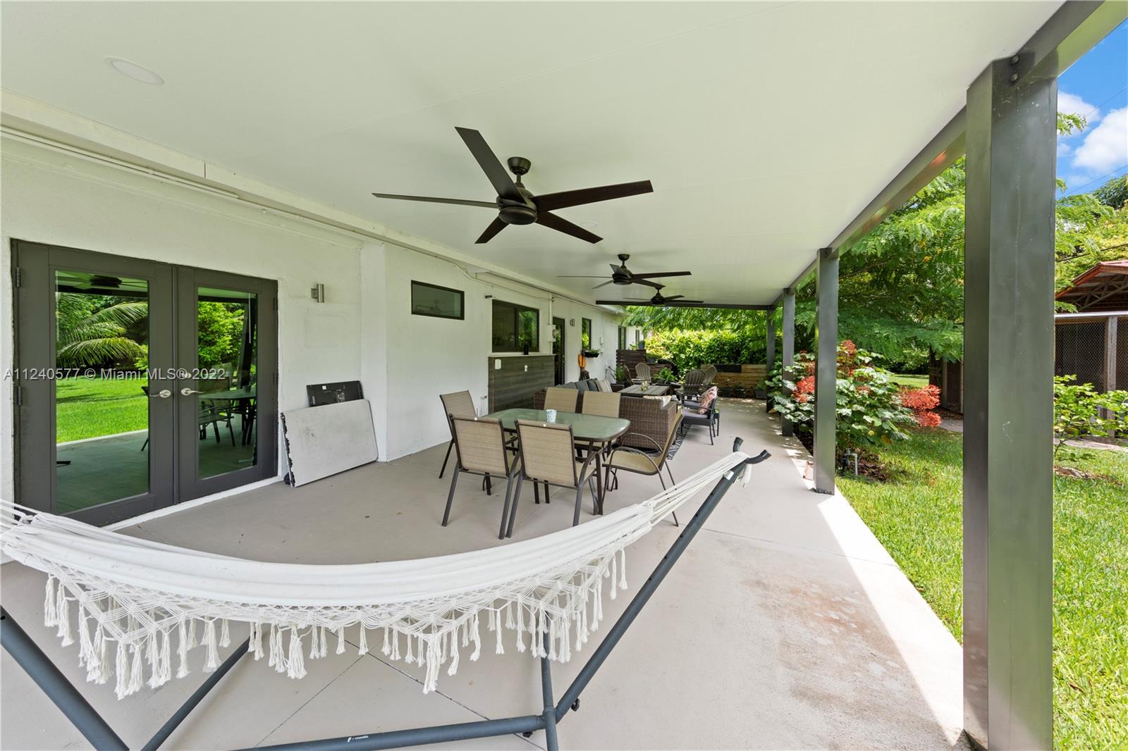 19760 Southwest 242nd Terrace Homestead, FL 33031 - Photo 25 of 49 a view of a patio with a table chairs and a patio