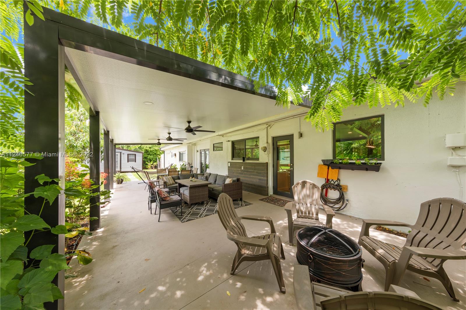 19760 Southwest 242nd Terrace Homestead, FL 33031 - Photo 26 of 49 a building outdoor space with patio furniture and potted plants