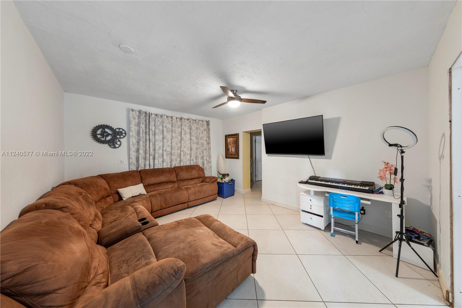 19760 Southwest 242nd Terrace Homestead, FL 33031 - Photo 31 of 49 a living room with furniture and a flat screen tv