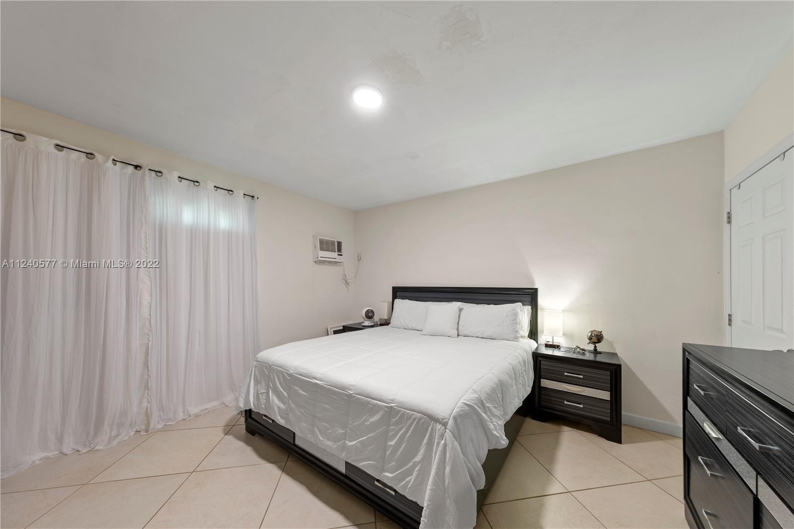 19760 Southwest 242nd Terrace Homestead, FL 33031 - Photo 32 of 49 a bedroom with a bed and a walk in closet