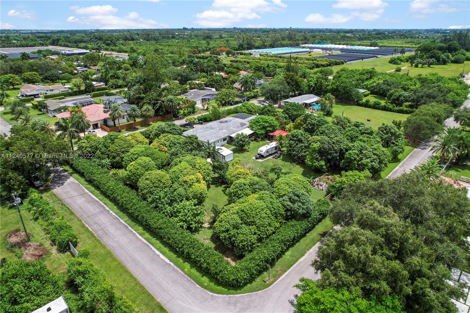 19760 Southwest 242nd Terrace Homestead, FL 33031 - Photo 37 of 49 an aerial view of residential houses with outdoor space and trees