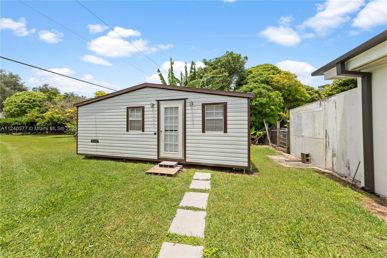 19760 Southwest 242nd Terrace Homestead, FL 33031 - Photo 45 of 49 a view of a house with a yard