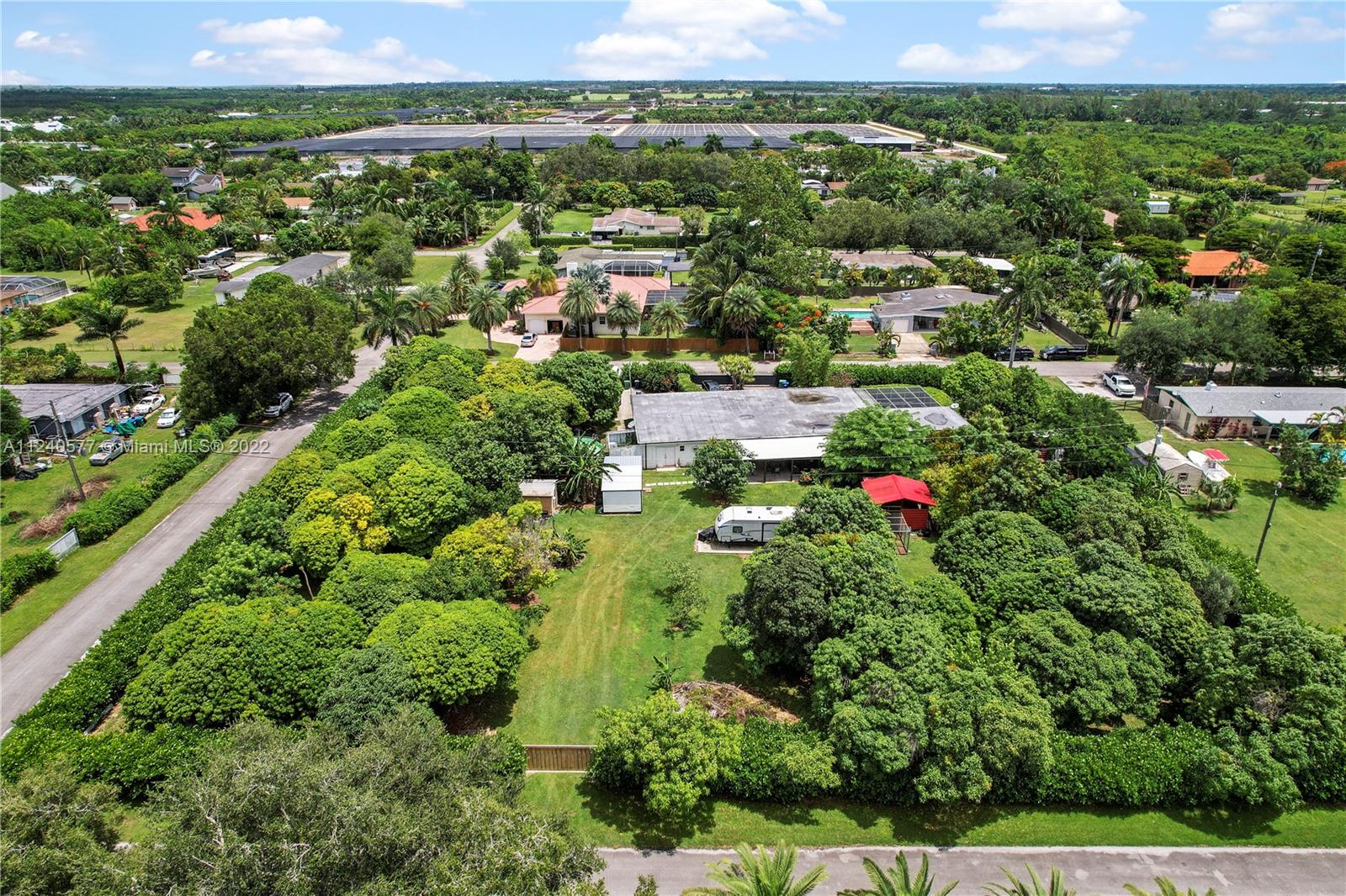 19760 Southwest 242nd Terrace Homestead, FL 33031 - Photo 47 of 49 an aerial view of residential houses with outdoor space and trees