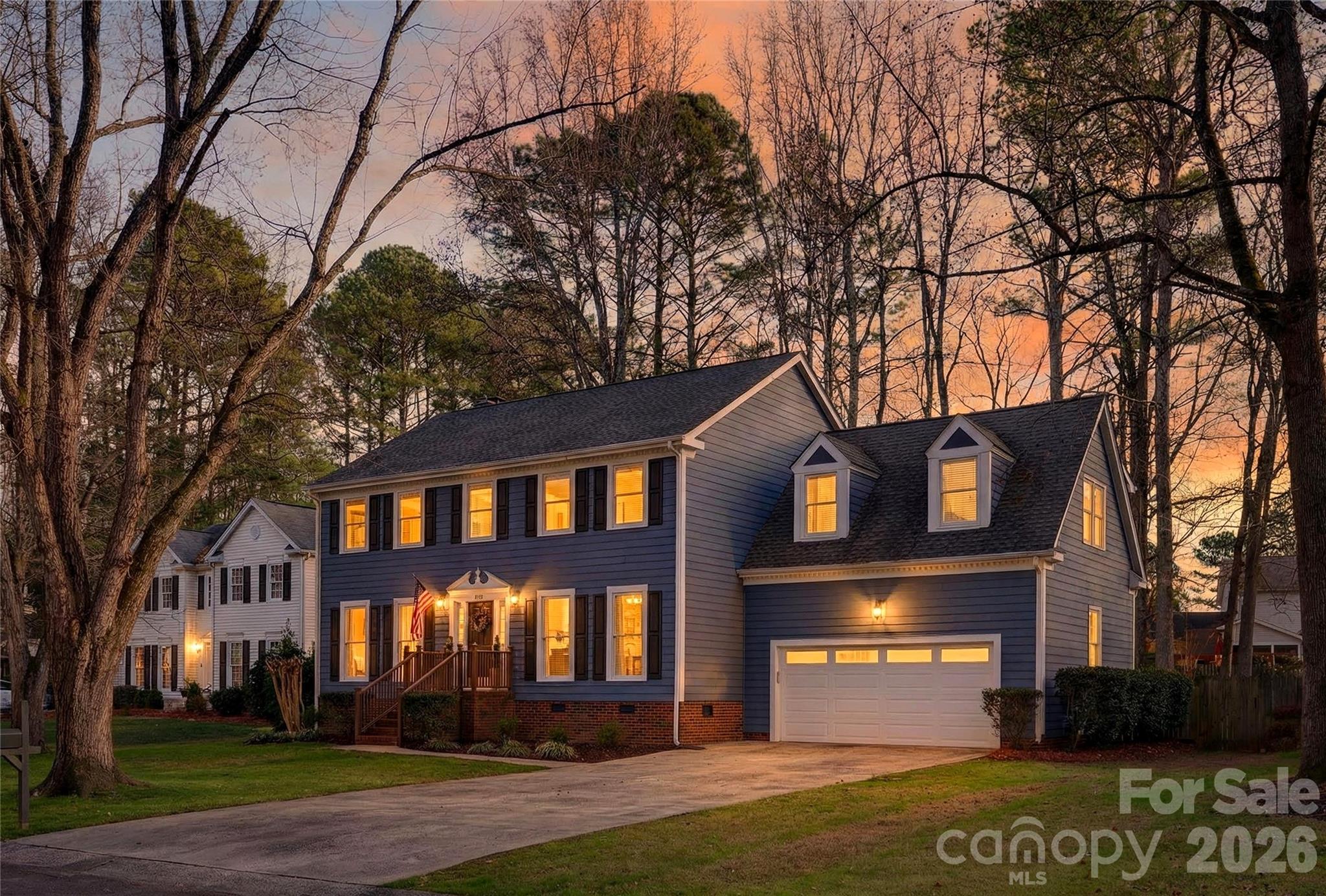 a front view of a house with a yard and a garage