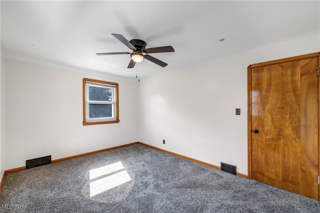 7822 Ridgefield Avenue Parma, OH 44129 - Photo 33 of 42 Carpeted empty room with a ceiling fan and baseboards