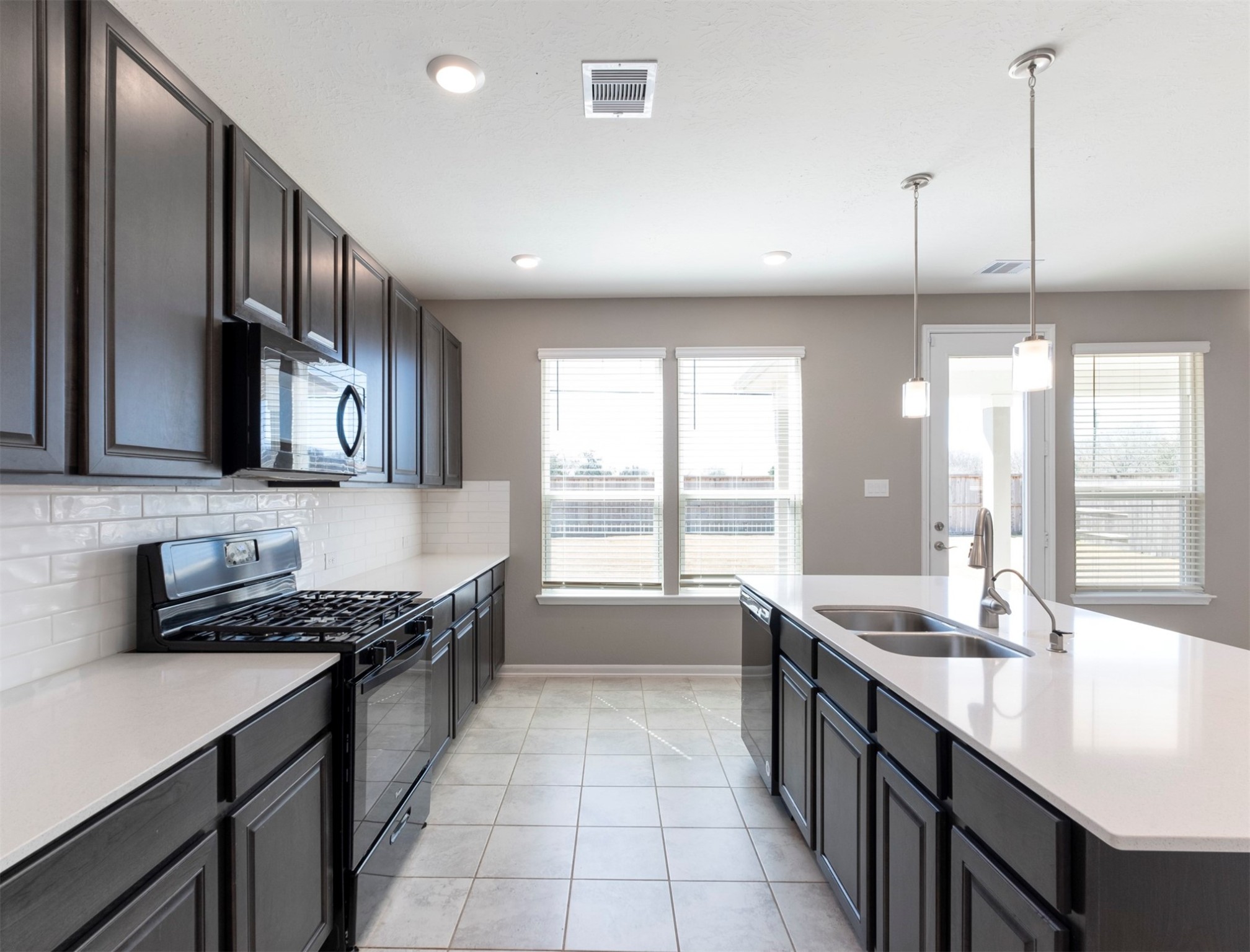 5712 Bluebonnet Lane Rosenberg, TX 77469 - Photo 6 of 16 a kitchen with stainless steel appliances granite countertop a sink a stove and a wooden floors