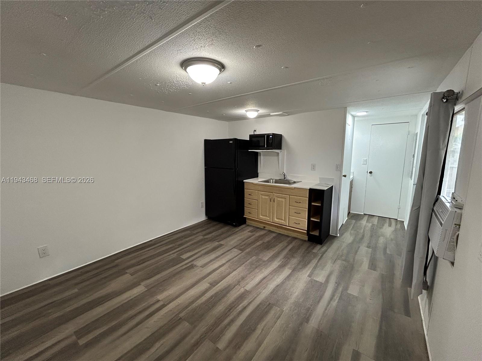 a view of a kitchen with a sink cabinets and a ceiling fan