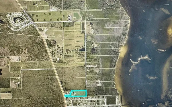 an aerial view of a house with a garden and lake view