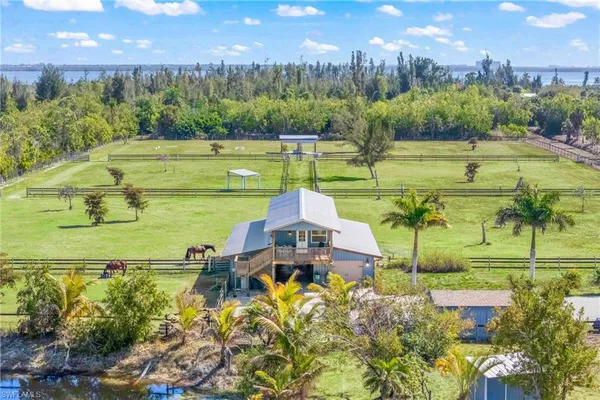a house view with a swimming pool and garden
