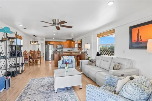 a kitchen with stainless steel appliances granite countertop a refrigerator and a stove top oven