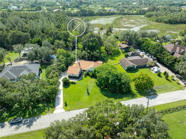 an aerial view of a house with pool outdoor seating and yard