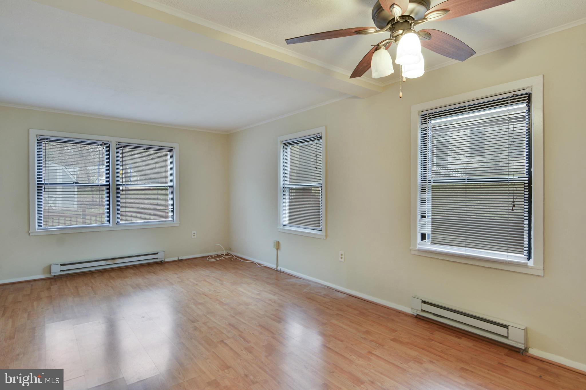 54 Ridge Road, Unit G Greenbelt, MD 20770 - Photo 10 of 30 a view of an empty room with wooden floor and a window