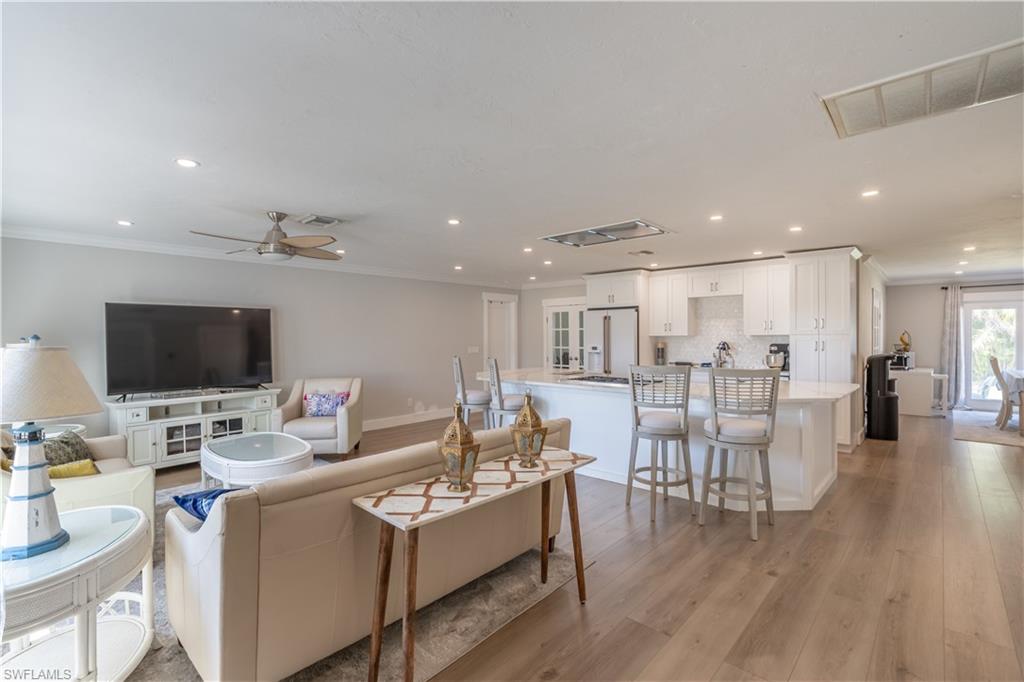 2237 Kings Lake Boulevard Naples, FL 34112 - Photo 14 of 49 a living room with furniture and a flat screen tv
