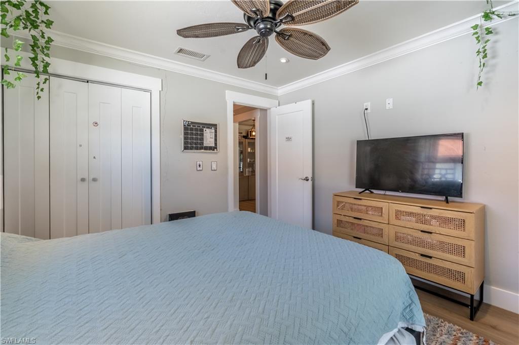 2237 Kings Lake Boulevard Naples, FL 34112 - Photo 29 of 49 a bedroom with a bed and a flat screen tv