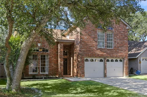 front view of a house with a tree
