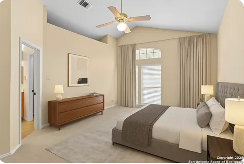 a spacious bedroom with a bed and a chandelier