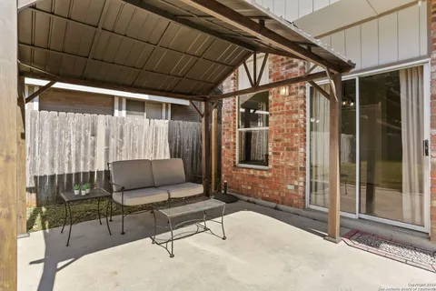 a outdoor living space with furniture and a ceiling fan