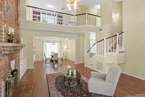 a living room with furniture a fireplace and a chandelier