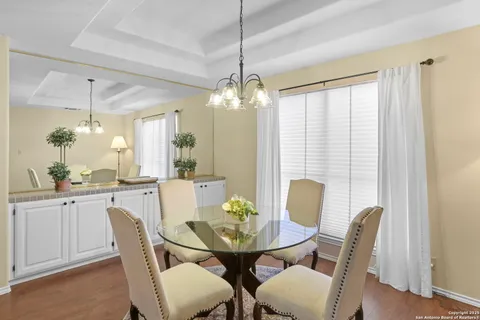 a view of a dining room with furniture and window