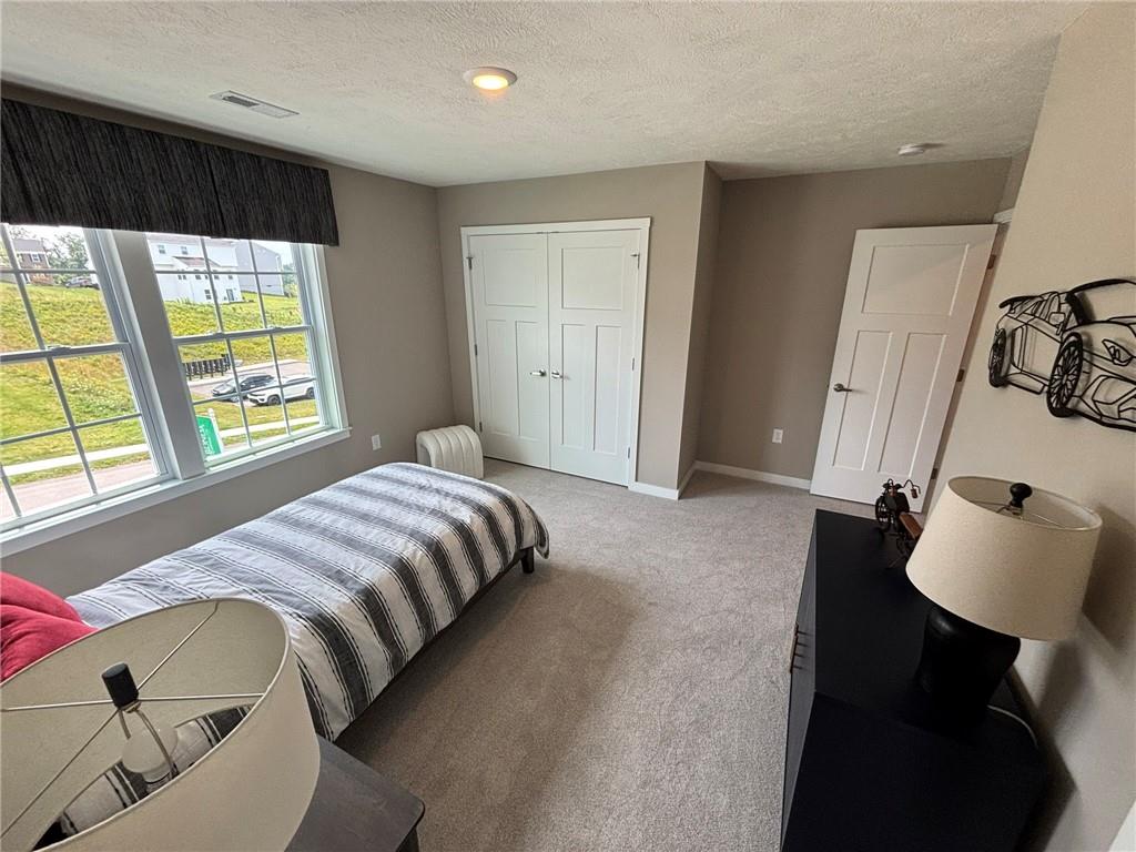 160 Raphael Court Clinton, PA 15026 - Photo 12 of 19 a bedroom with a bed and a window