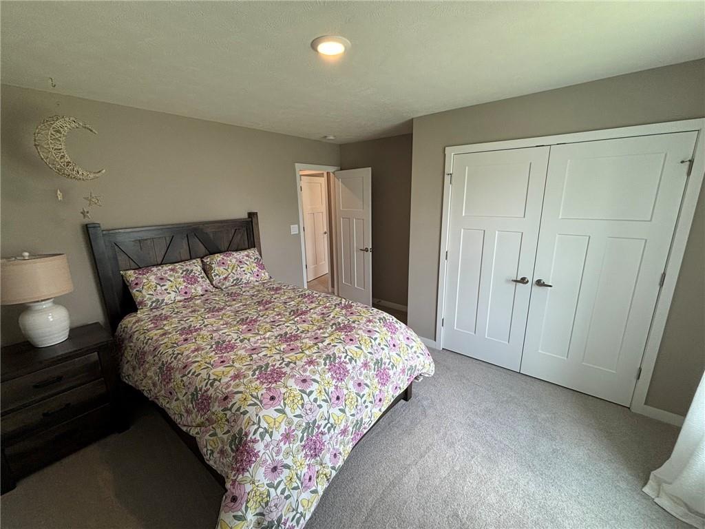 160 Raphael Court Clinton, PA 15026 - Photo 13 of 19 a bed sitting in a bedroom next to a bathroom