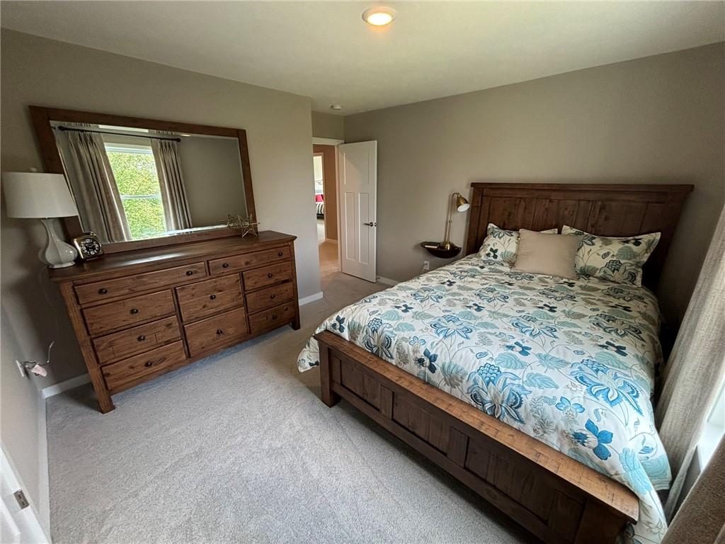 160 Raphael Court Clinton, PA 15026 - Photo 18 of 19 a bedroom with a bed and a mirror on dresser