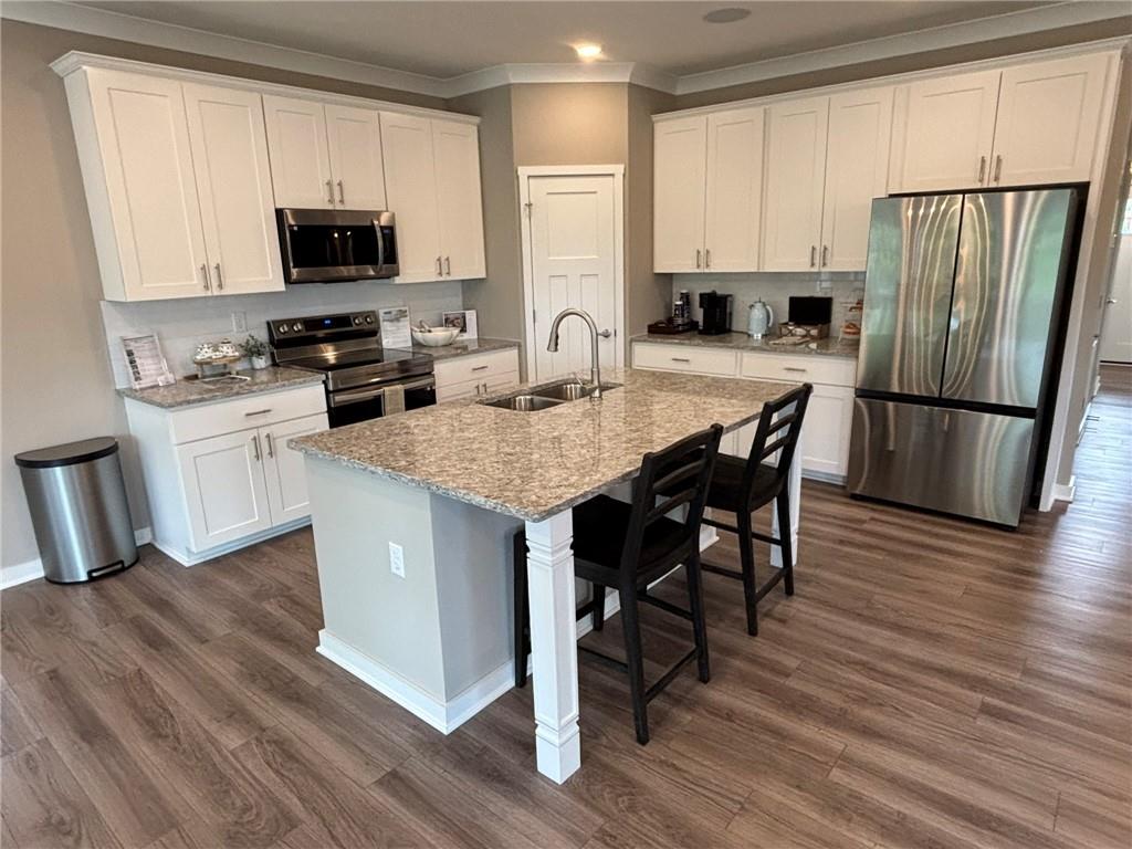 160 Raphael Court Clinton, PA 15026 - Photo 2 of 19 a kitchen with stainless steel appliances a white refrigerator a stove a sink a dining table and chairs