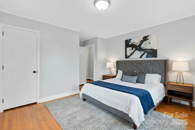 a bedroom with bed and a night stand