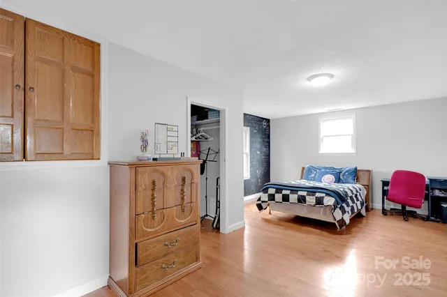 a spacious bedroom with a bed and a cabinets