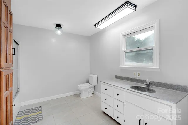 a bathroom with a sink a toilet and a mirror