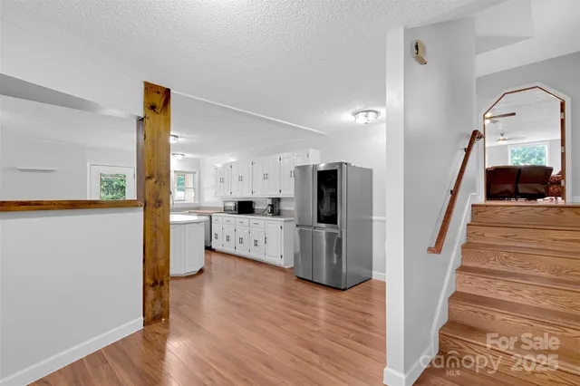 a view of living room with furniture and wooden floor