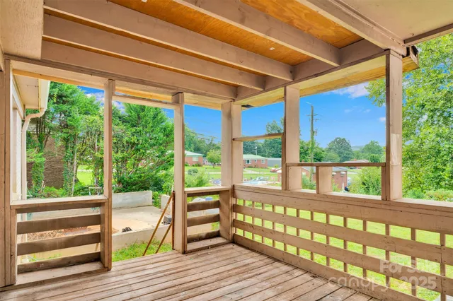 a view of porch with a floor to ceiling window and wooden floor