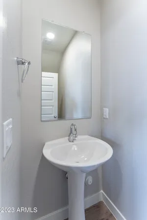 an empty room with closet and a chandelier fan