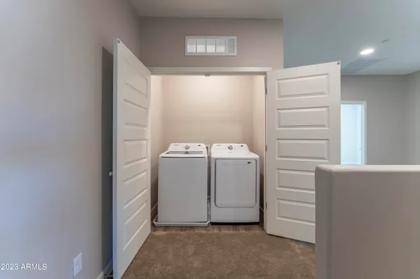a bathroom with a double vanity sink a mirror and a shower