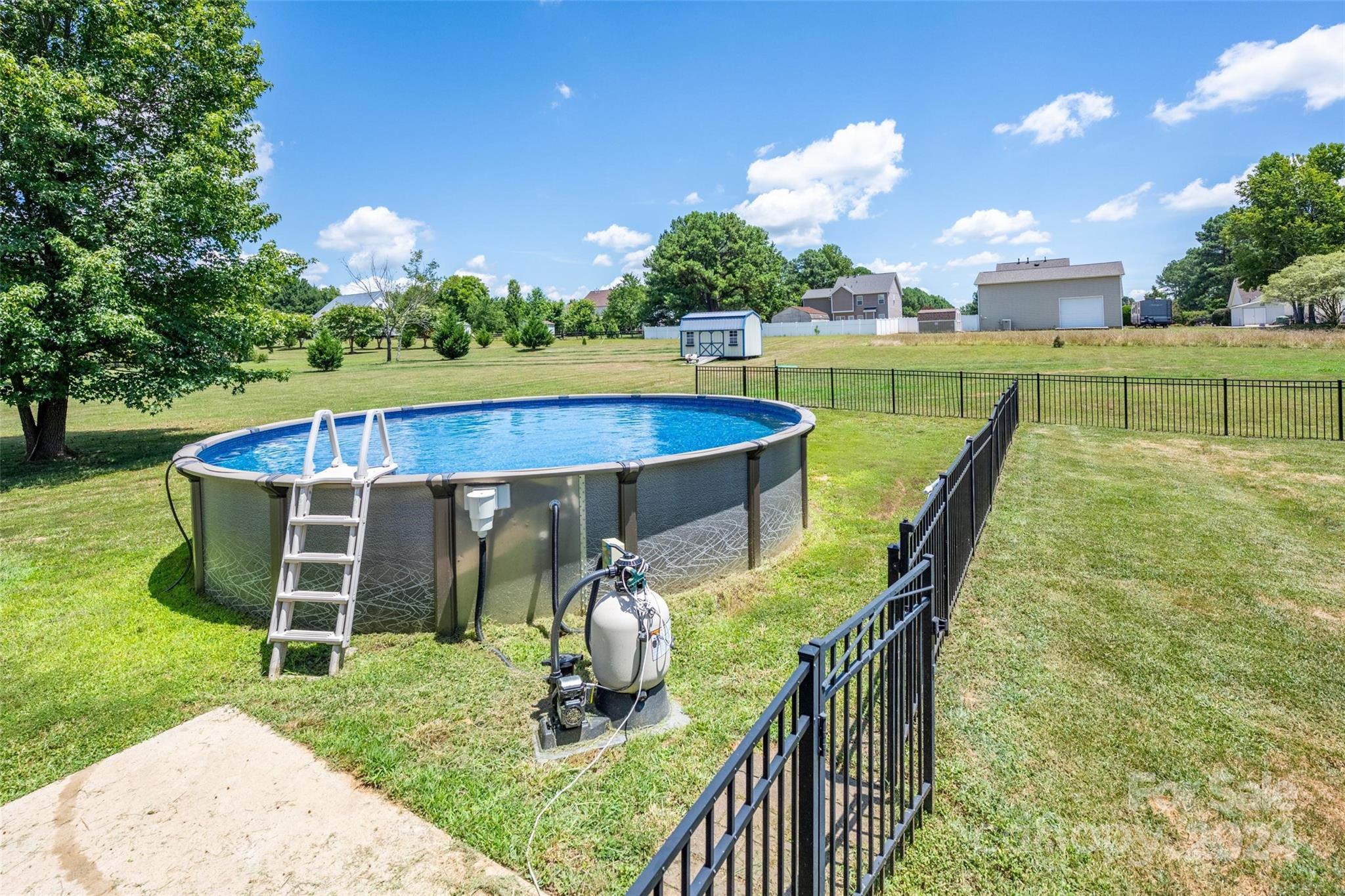 395 Hoover Road Troutman, NC 28166 - Photo 4 of 26 a view of a swimming pool with a patio and a garden