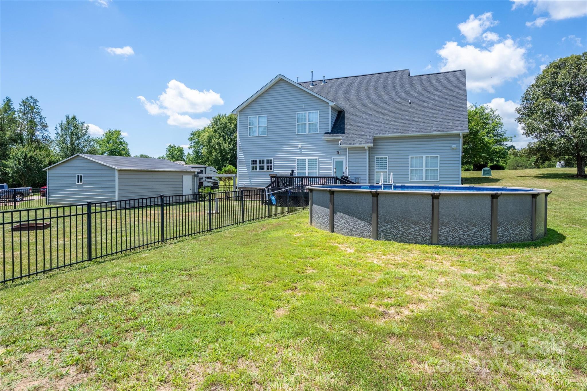 395 Hoover Road Troutman, NC 28166 - Photo 6 of 26 a view of a house with a backyard and a garden