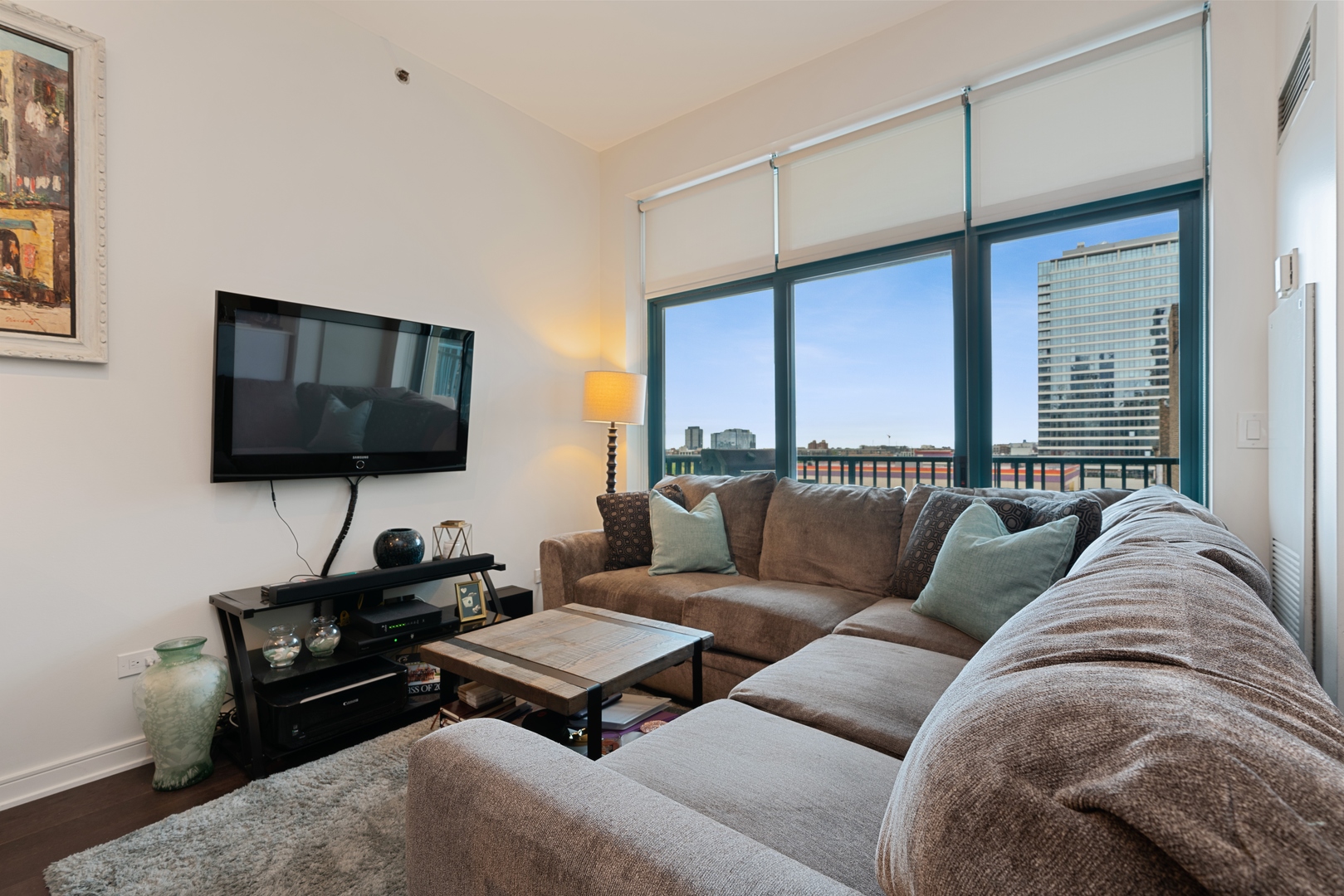 340 West Superior Street, Unit 910 Chicago, IL 60654 - Photo 3 of 10 a living room with furniture a flat screen tv and a window